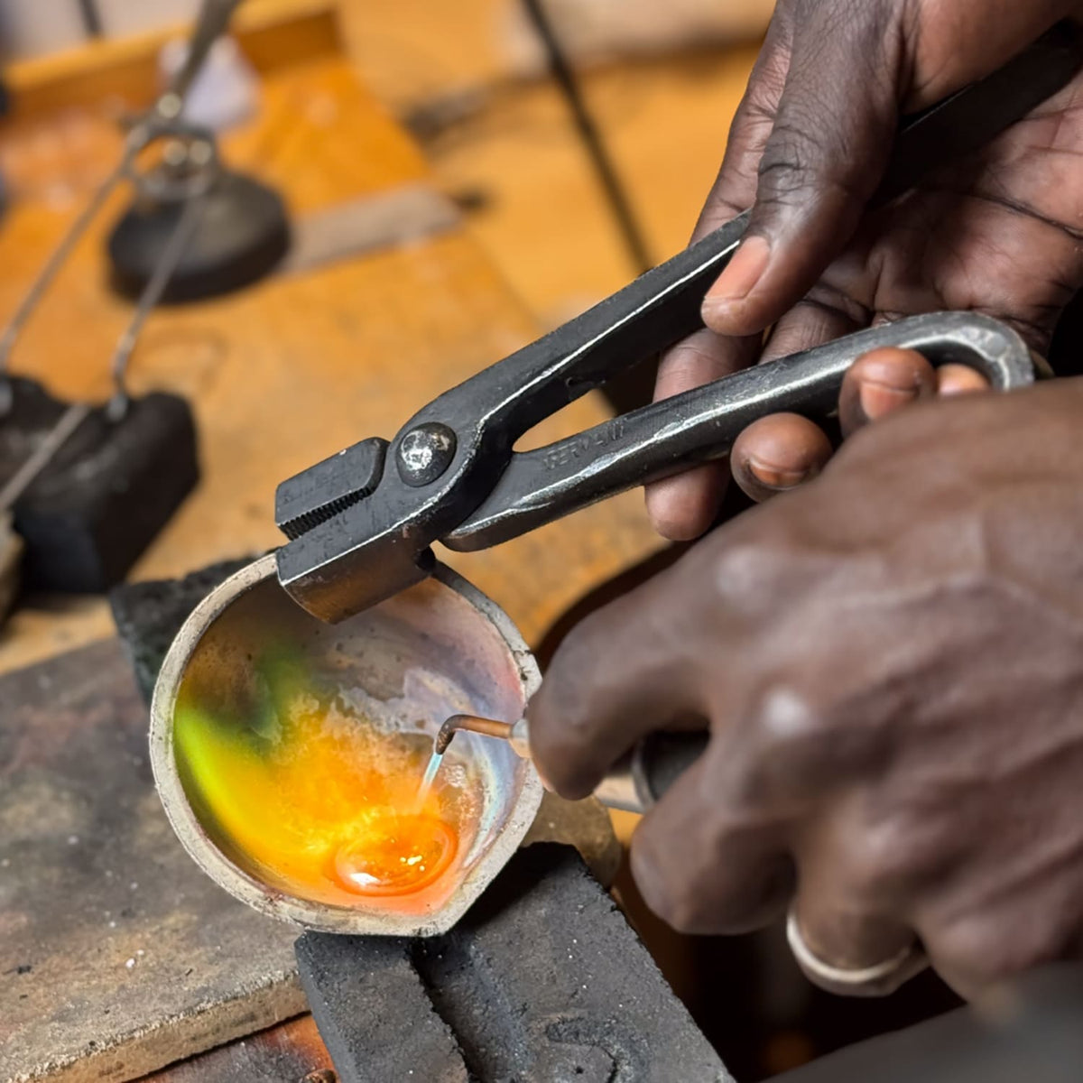 Jewelry tools and materials on a workshop bench.