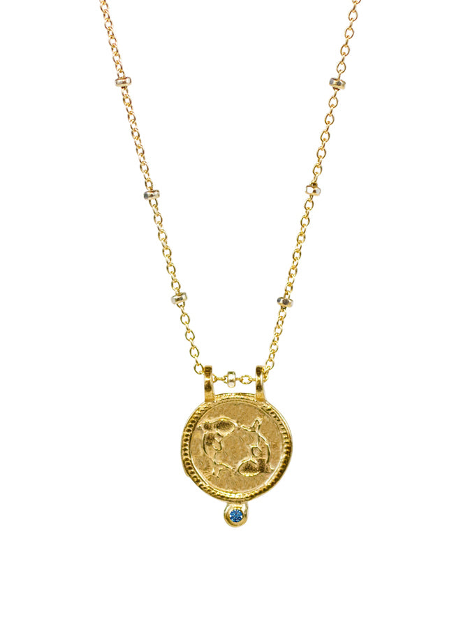 Pisces Necklace in yellow bronze with blue diamond by Lulu Designs.